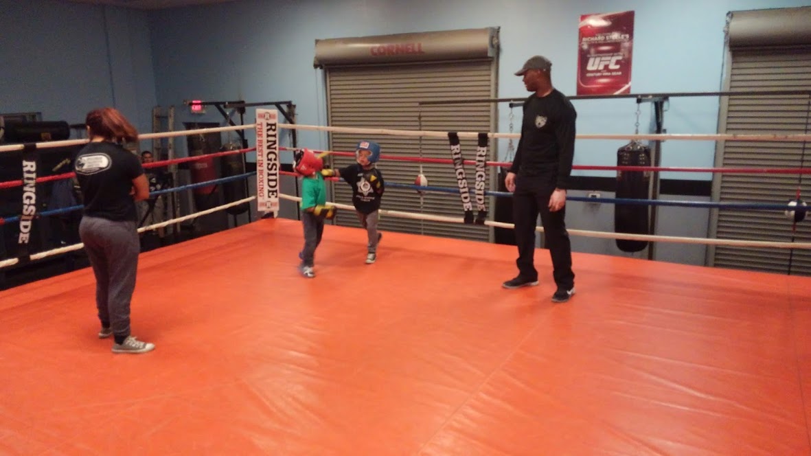 children training inside the boxing ring